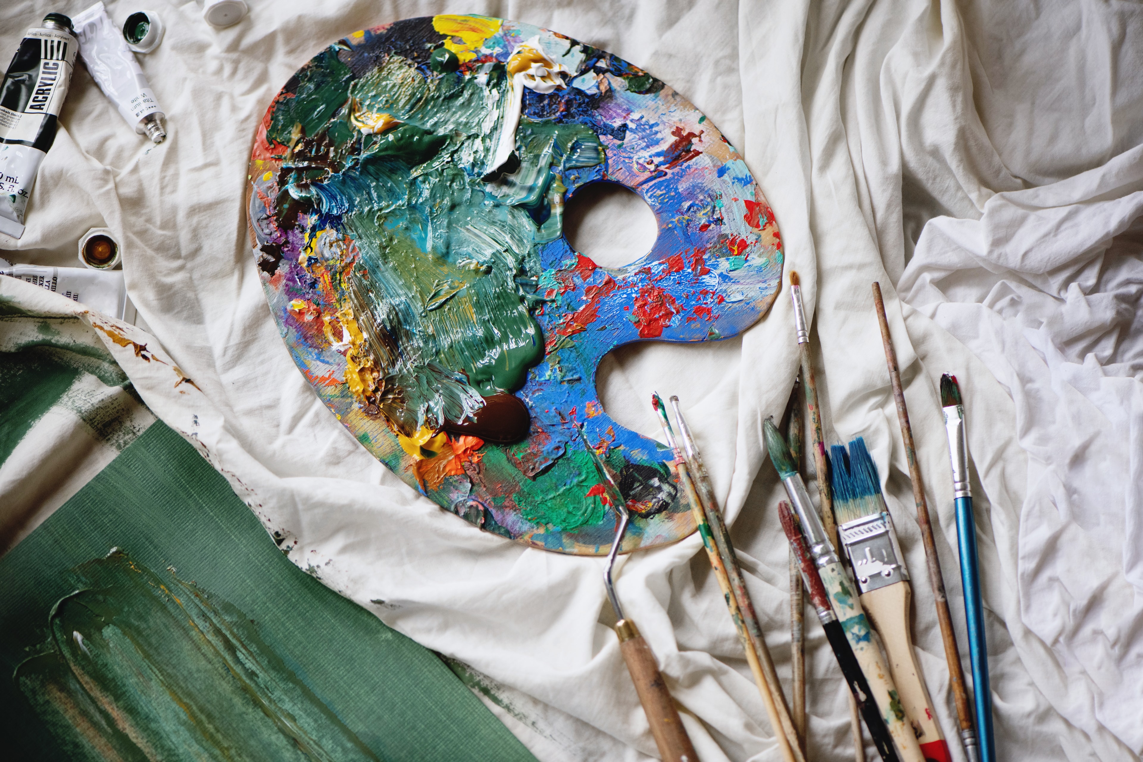 Artist's palette with acrylic paints and brushes