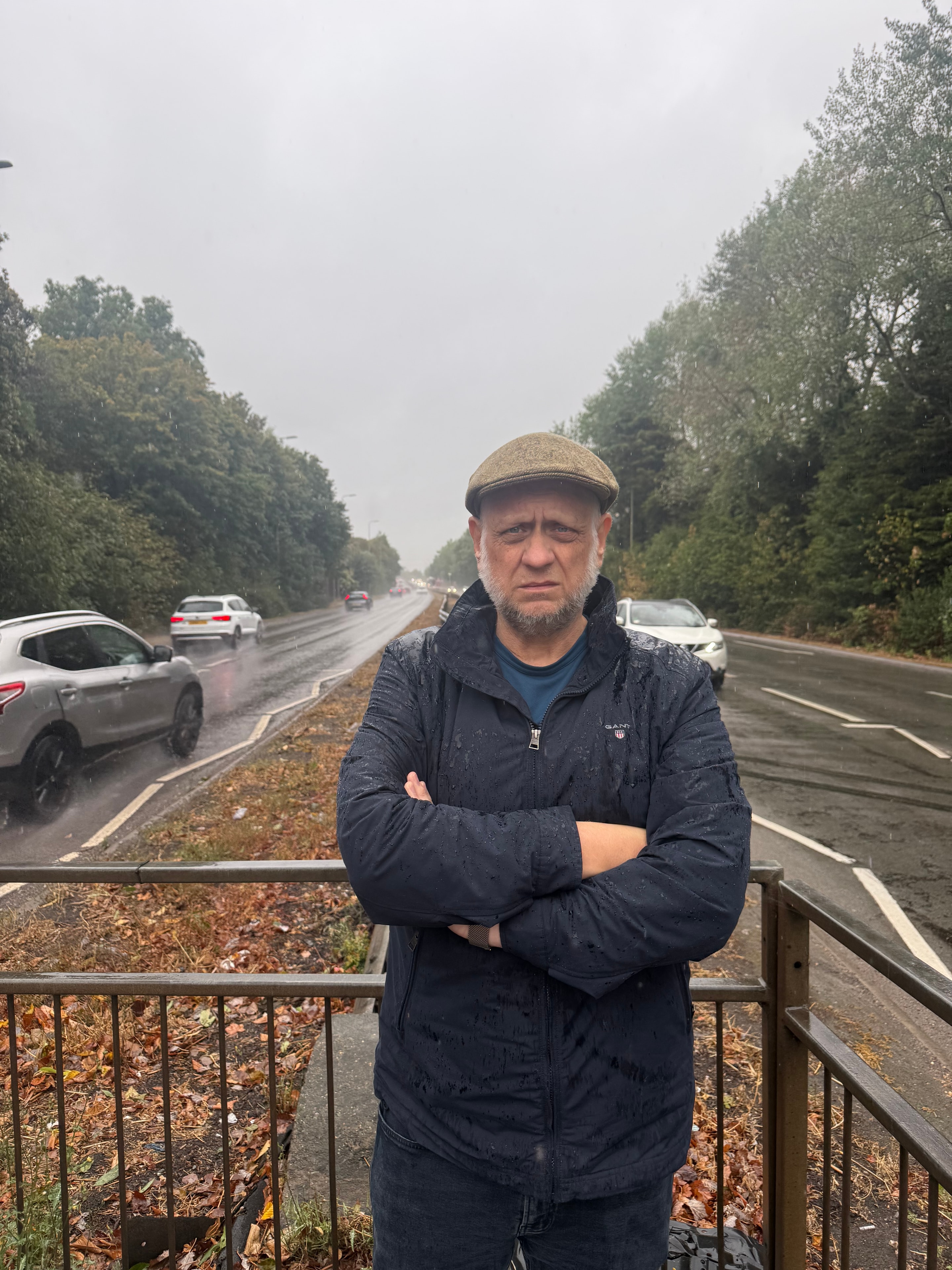 Paul-Austin Sargent standing beside Hennef Way in rainy weather
