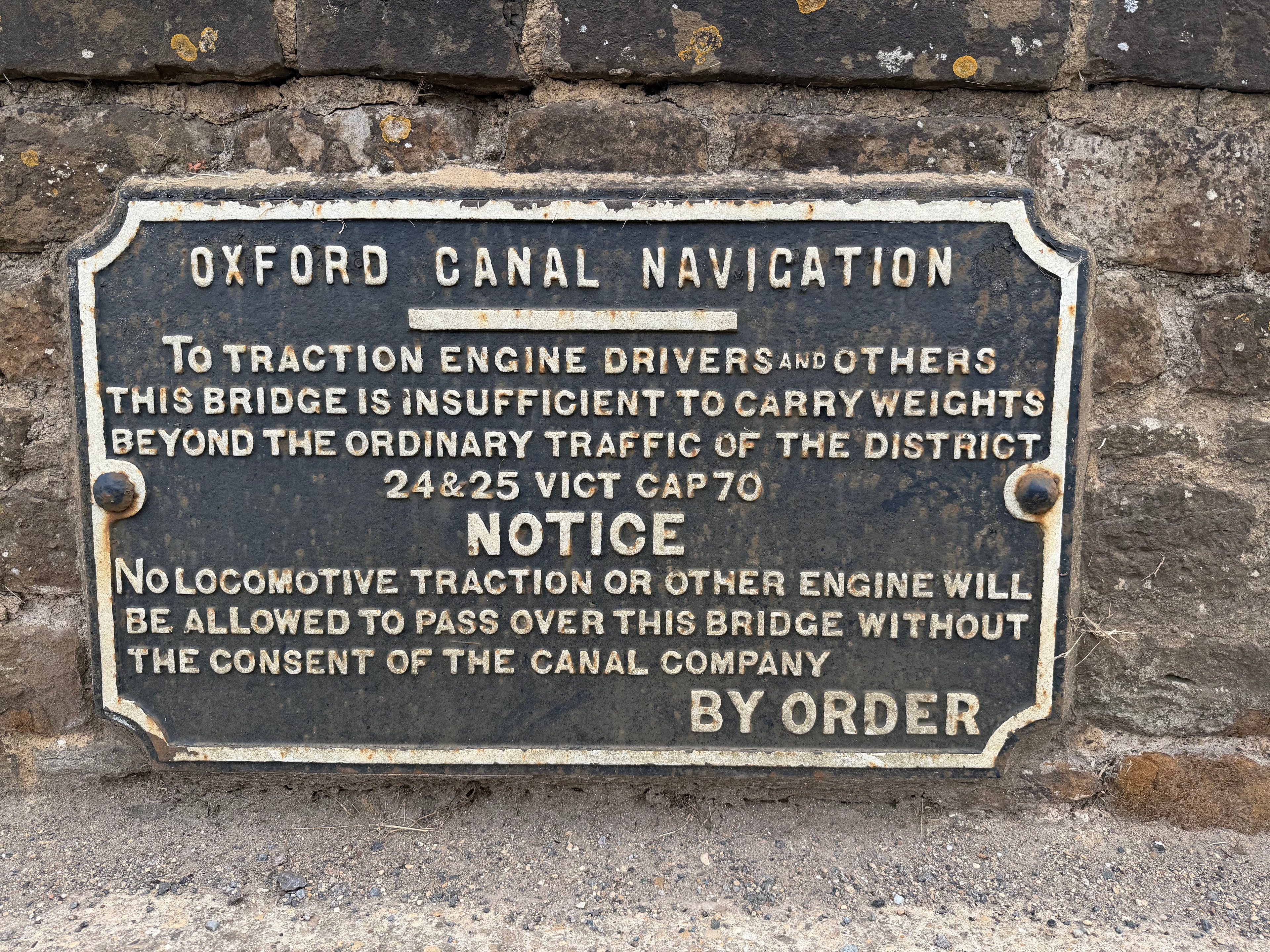 Victorian cast iron Oxford Canal Navigation plaque on stone bridge, warning traction engine drivers of weight limits